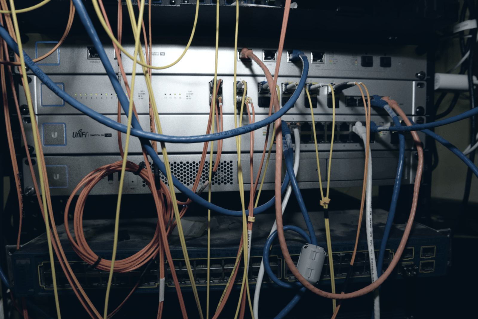 Patch cords and fibre running into a network rack